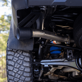 Close-up of a vehicle's exhaust system with a muffler and pipe
