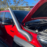 Red car with an open hood and a silver protective grille guard.