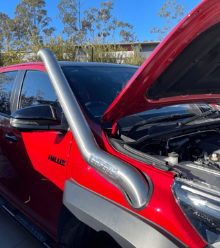 Red car with an open hood and a silver protective grille guard.