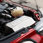 Car engine with a visible 'torqit' logo on a red car.