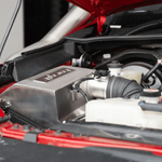 Close-up of a car engine with visible branding