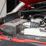Close-up of a car engine with visible branding