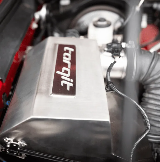 Close-up of a 'torqit' airbox on a vehicle, with visible branding.