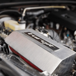 Close-up of a car engine with a prominent 'Torqit' label.