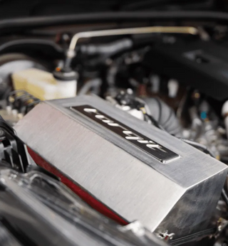 Close-up of a car engine with a prominent 'Torqit' label.
