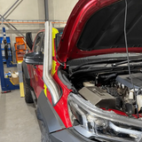 Red car with in a garage setting