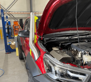 Red car with in a garage setting