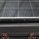 Solar panel on a bush company tent with visible brand name.