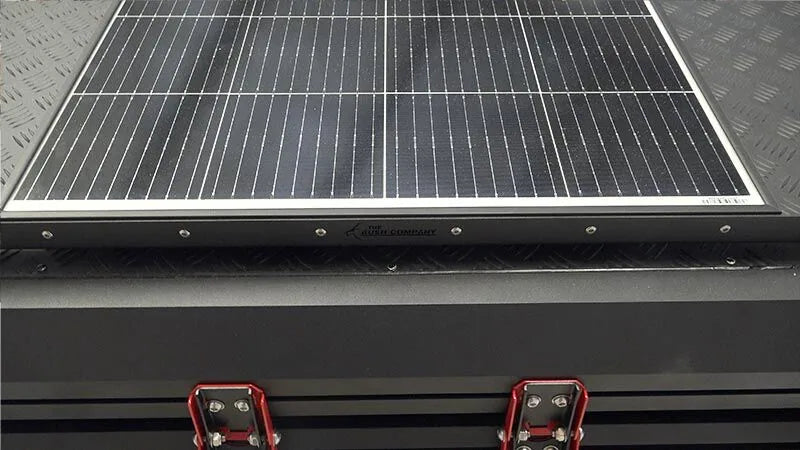 Solar panel on a bush company tent with visible brand name.