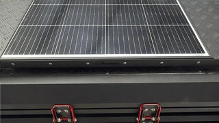 Solar panel on a bush company tent with visible brand name.