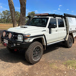 White off-road vehicle with black accents on a dirt road