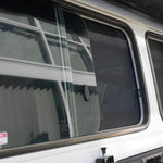 Close-up of a vehicle window with security stickers on a white background
