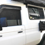 White Land Cruiser vehicle with black roof rack and side windows