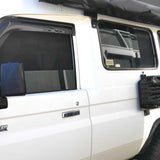 White Land Cruiser vehicle with black roof rack and side windows