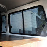 Interior of a vehicle with a large window showing a building outside