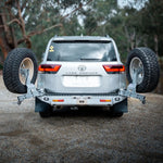 Toyota Land Cruiser with a spare tire mounted in a forest setting