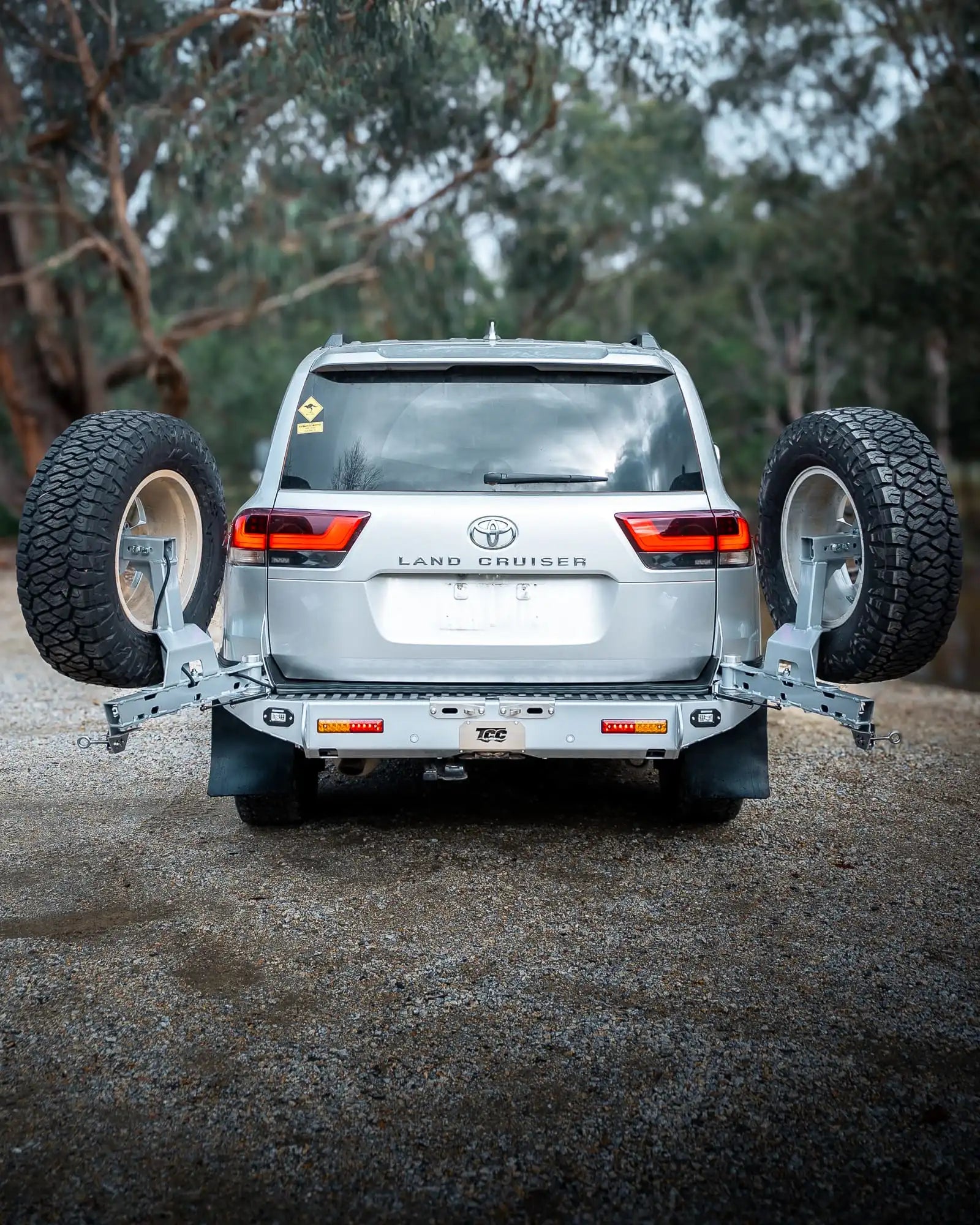 Toyota Land Cruiser with a spare tire mounted in a forest setting