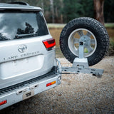 Silver Toyota Land Cruiser with a spare tire mounted