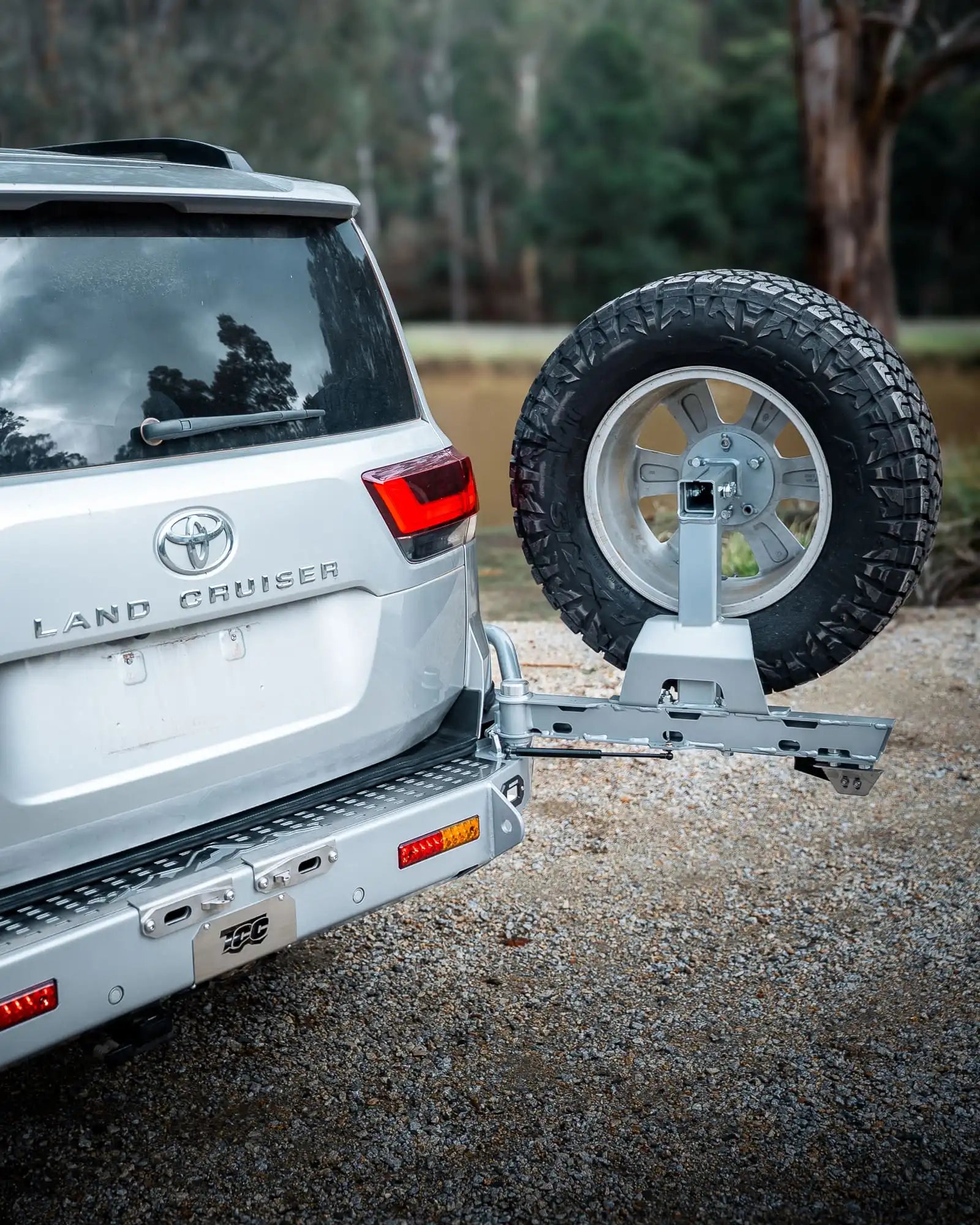 Silver Toyota Land Cruiser with a spare tire mounted