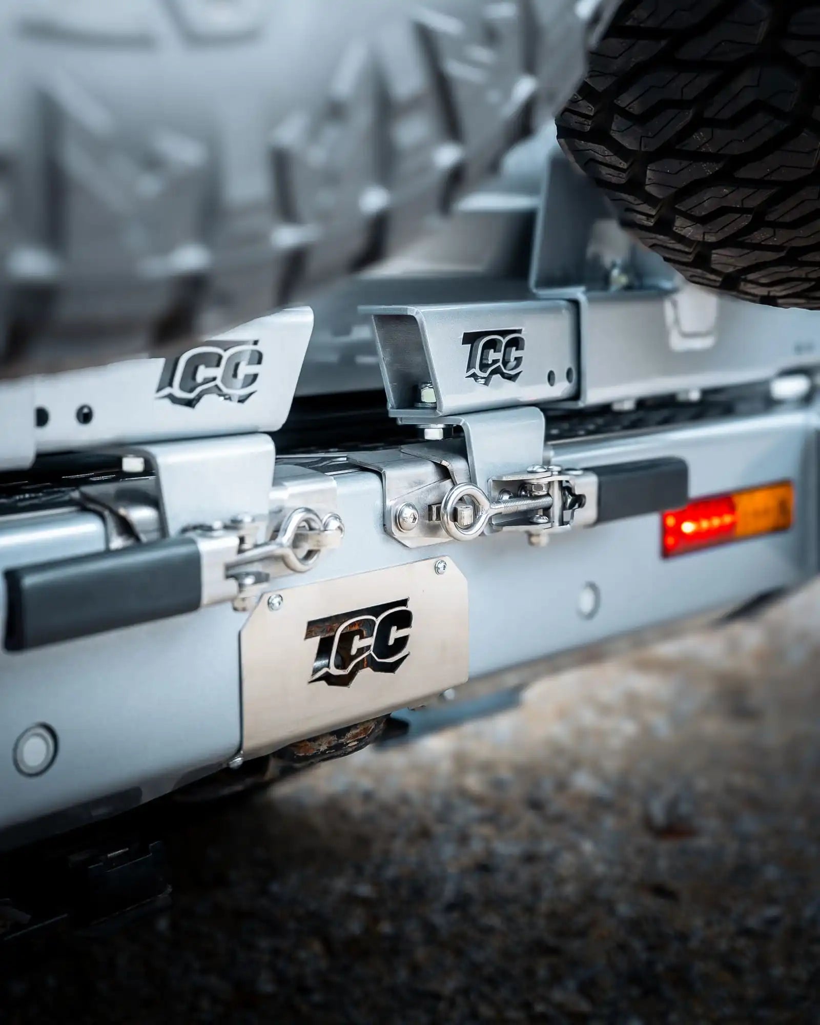 Close-up of a vehicle's hitch receiver with TCC branding.