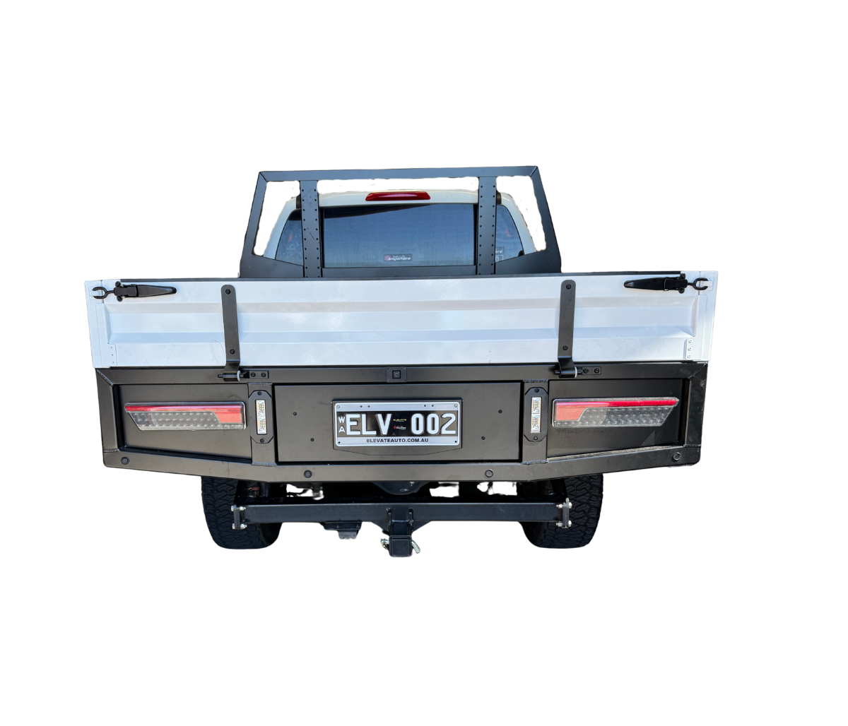 Back view of a truck with a flatbed and license plate on a white background
