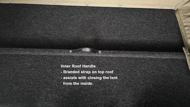 Close-up of a black inner roof handle on a tent with text description.