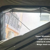 Window of a tent with text describing features, showing a building outside.