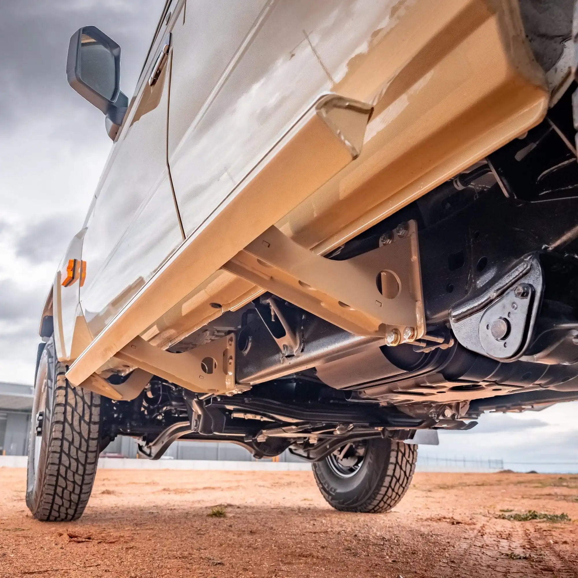 Close-up of a vehicle's undercarriage with a clear sky background