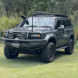 Gray Toyota prado 250 with off-road equipment on a grassy area
