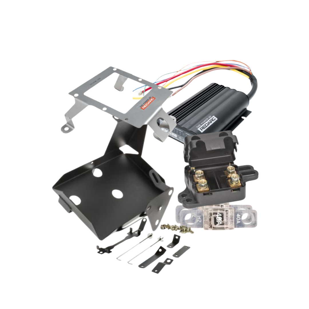 Under bonnet dual battery kit for the LandCruiser 200 Series laid out: REDARC BCDC1225D charger with wiring loom, stainless charger bracket, black battery tray, twin midi fuse holder, 40A midi fuses and mounting hardware