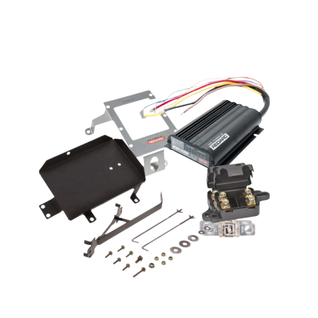 Under bonnet dual battery kit contents for the Isuzu D-MAX 3.0 turbo diesel 4JJ1-TC, showing the REDARC BCDC1225D charger, stainless bracket, battery tray, fuses and wiring