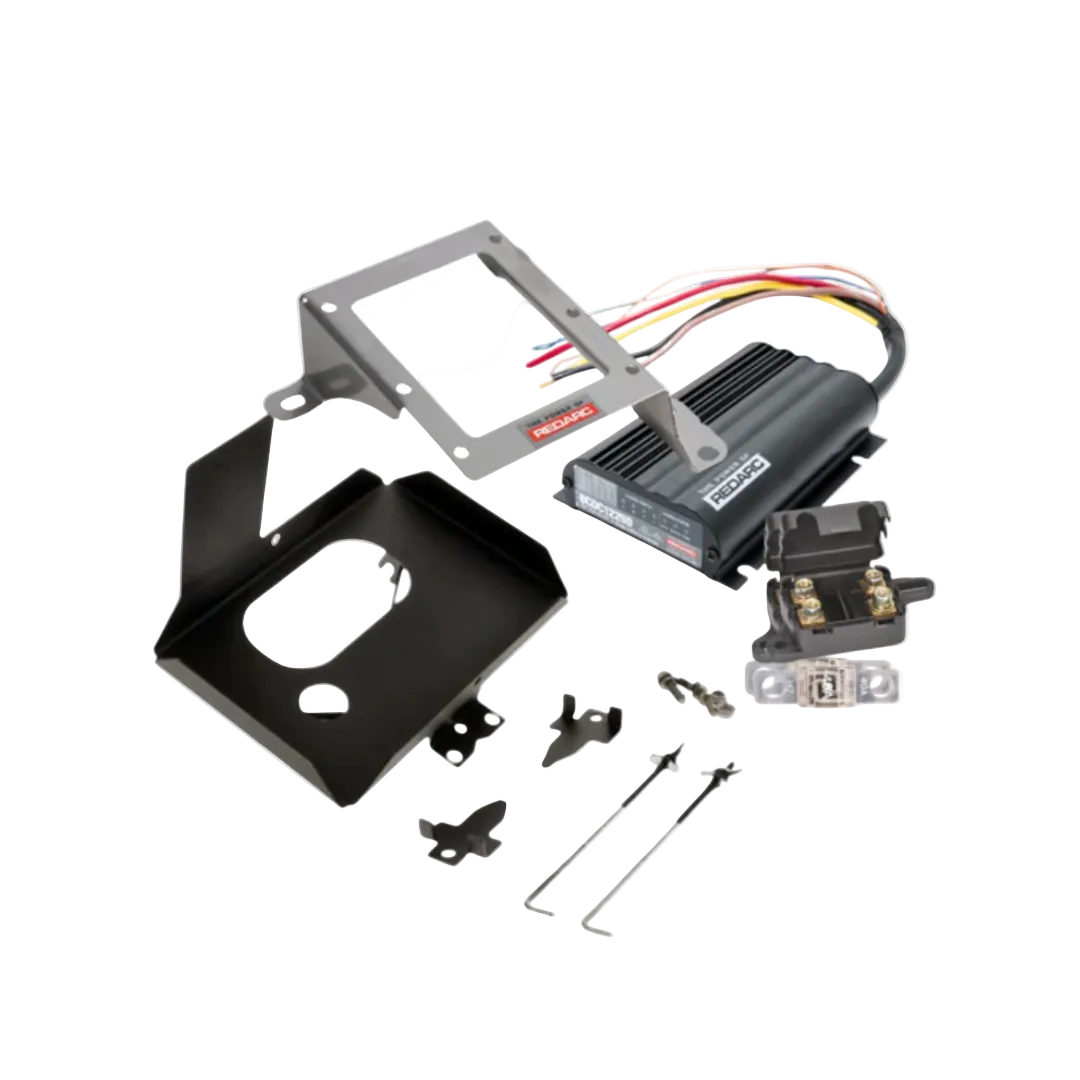 Under bonnet dual battery kit contents for the Mitsubishi Triton MQ-MR 2.4 turbo diesel, showing the REDARC BCDC1225D charger, stainless bracket, battery tray, fuses and wiring