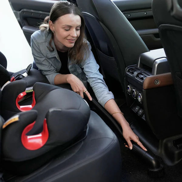 Woman using the Blahst K21 Wall-Mounted Vacuum in a vehicle