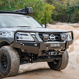 Off-road vehicle on a dirt road with trees in the background