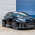 Black Toyota car parked in front of a blue and gray striped wall with Lazer Lamps Bumper Beam Mount Kit for Toyota Yaris GR