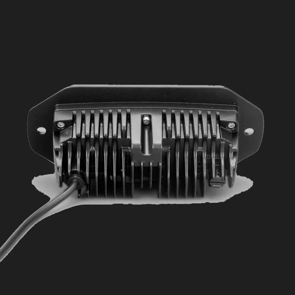 The CX4 flush mount seen square on from behind, the finned heatsink centred in the flange with a fixing hole at each end and the lead running out to one side