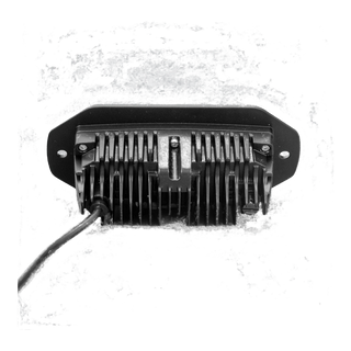 The CX4 flush mount seen square on from behind, the finned heatsink centred in the flange with a fixing hole at each end and the lead running out to one side