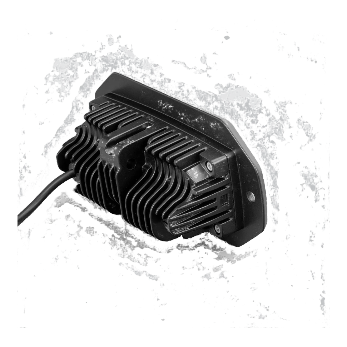 Rear of the CX4 flush mount light, showing the deep finned heatsink behind the mounting flange, the retaining screws and the cable leaving the back