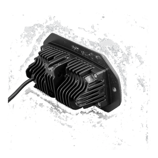 Rear of the CX4 flush mount light, showing the deep finned heatsink behind the mounting flange, the retaining screws and the cable leaving the back