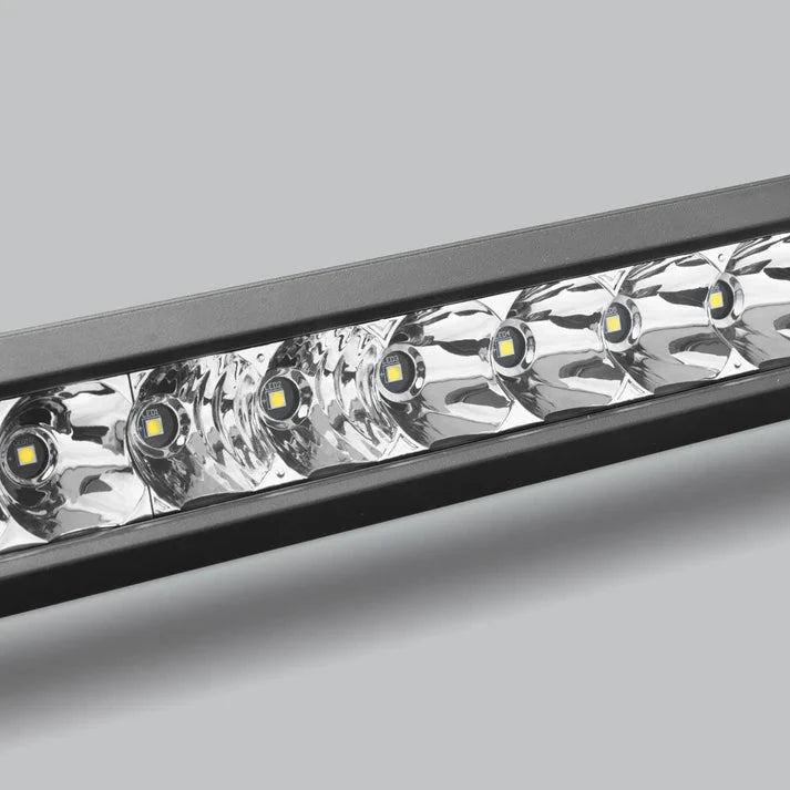 Close-up across the spot section of the bar, a row of LEDs each sitting in a deep polished reflector behind the lens