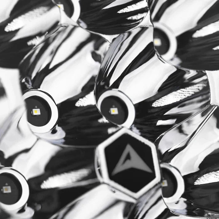 Macro of the Rogue reflector, individual LEDs seated in polished chrome cups around a hexagonal centre badge carrying the ALTIQ arrow