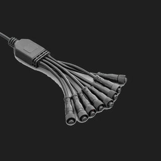 Eight-way splitter loom for the rock light kit, a moulded junction block with one feed lead in and eight sealed screw-lock connectors out, laid on a grey ground