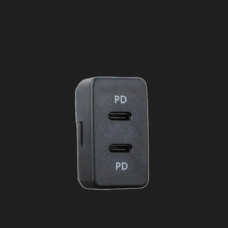 Toyota-fit dual USB-C charger, the black face carrying two USB-C ports each marked PD, with the body extending back behind the panel