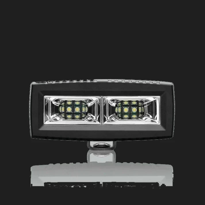 ALTIQ CX4 scene work light square on, a wide rectangular lens holding two reflector segments each with a dense cluster of LEDs, in a black housing with the mounting bracket beneath