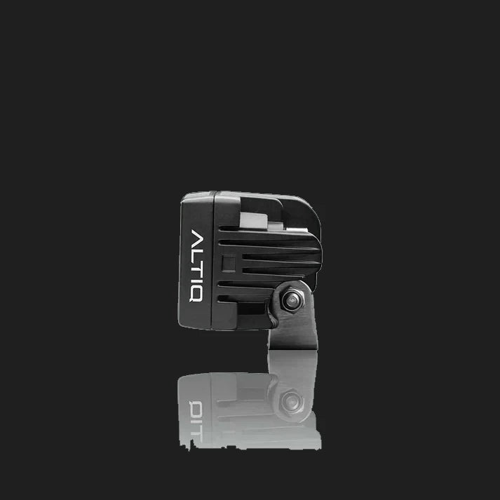 ALTIQ CX4 work light seen from the side, the ribbed black housing with the ALTIQ name down the face and the stainless mounting bracket below