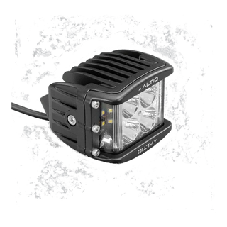 DX4 hybrid work light at a three-quarter angle, showing the round spot optics and the side flood strip together behind the clear lens