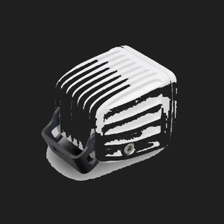 White DX4 Scene work light from behind and above, the finned white heatsink with the black bracket wrapping underneath
