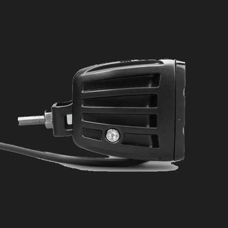 Black DX4 Scene work light side on, the ribbed housing profile with the mounting bracket bolted through the flank and the cable running forward