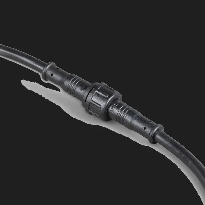 Two sealed two-pin connectors of the rock light harness screwed together, the knurled locking collar joining the male and female halves with strain-relief mouldings at each end