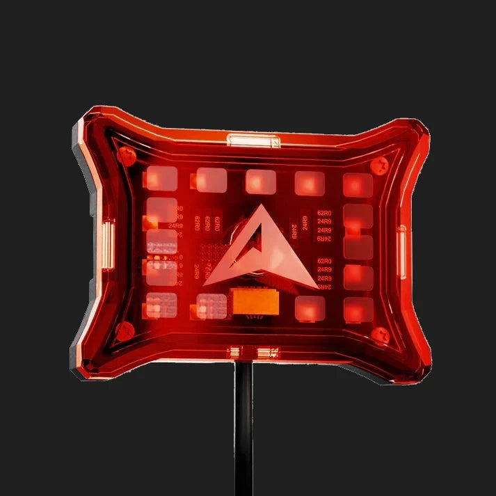 Red rock light cover lit from behind, the LEDs glowing through the panel with the resistor markings on the board visible and the ALTIQ arrow in the middle
